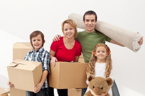 Professional movers handling desks and IT equipment during an office relocation